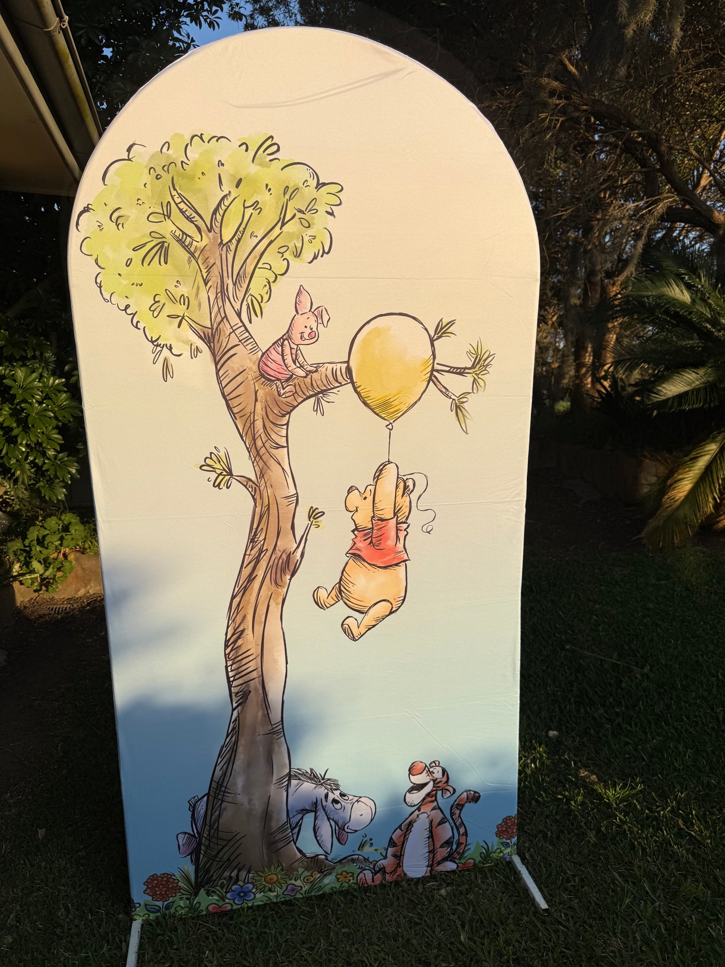 Bear on a balloon arch