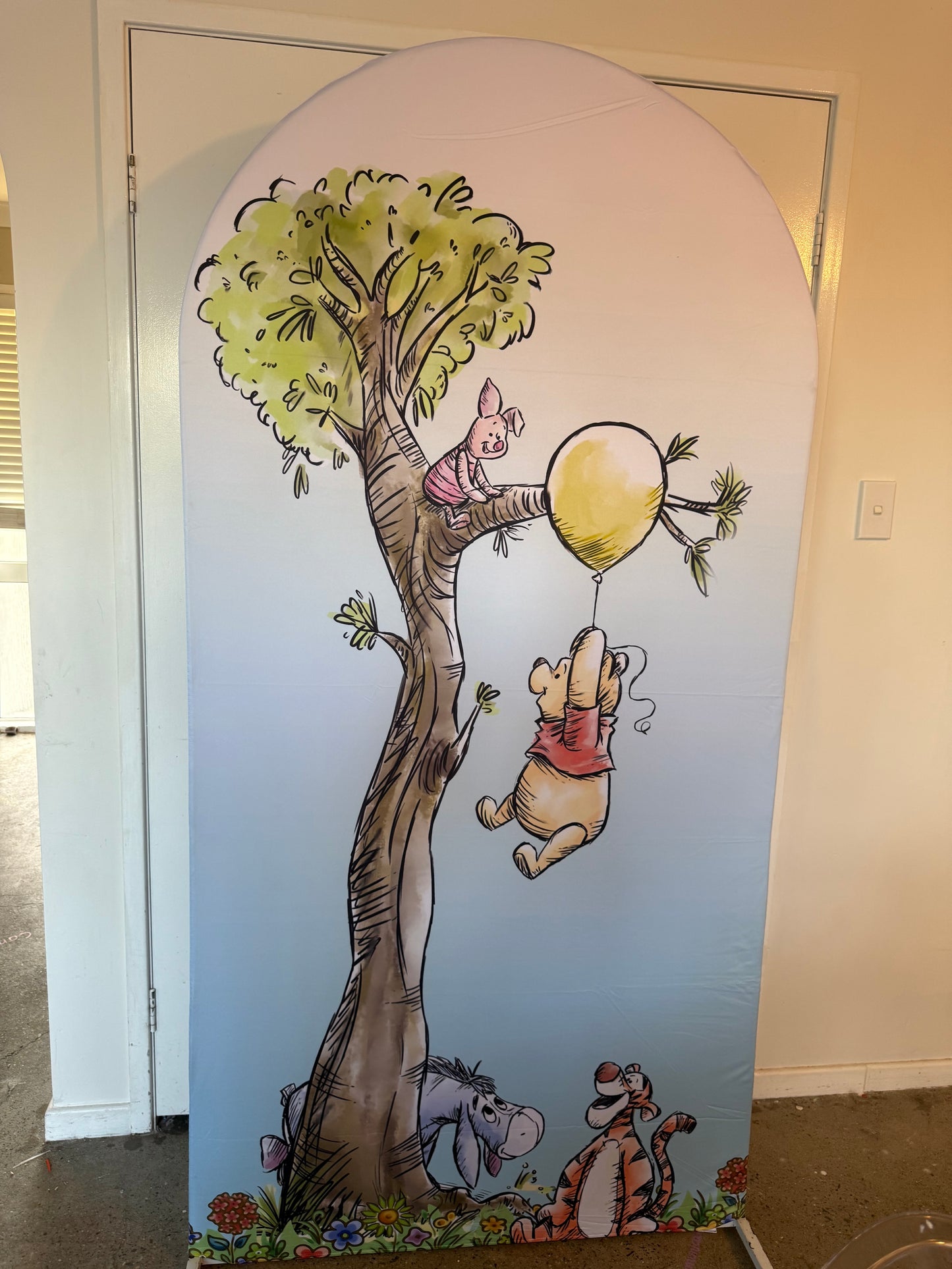 Bear on a balloon arch
